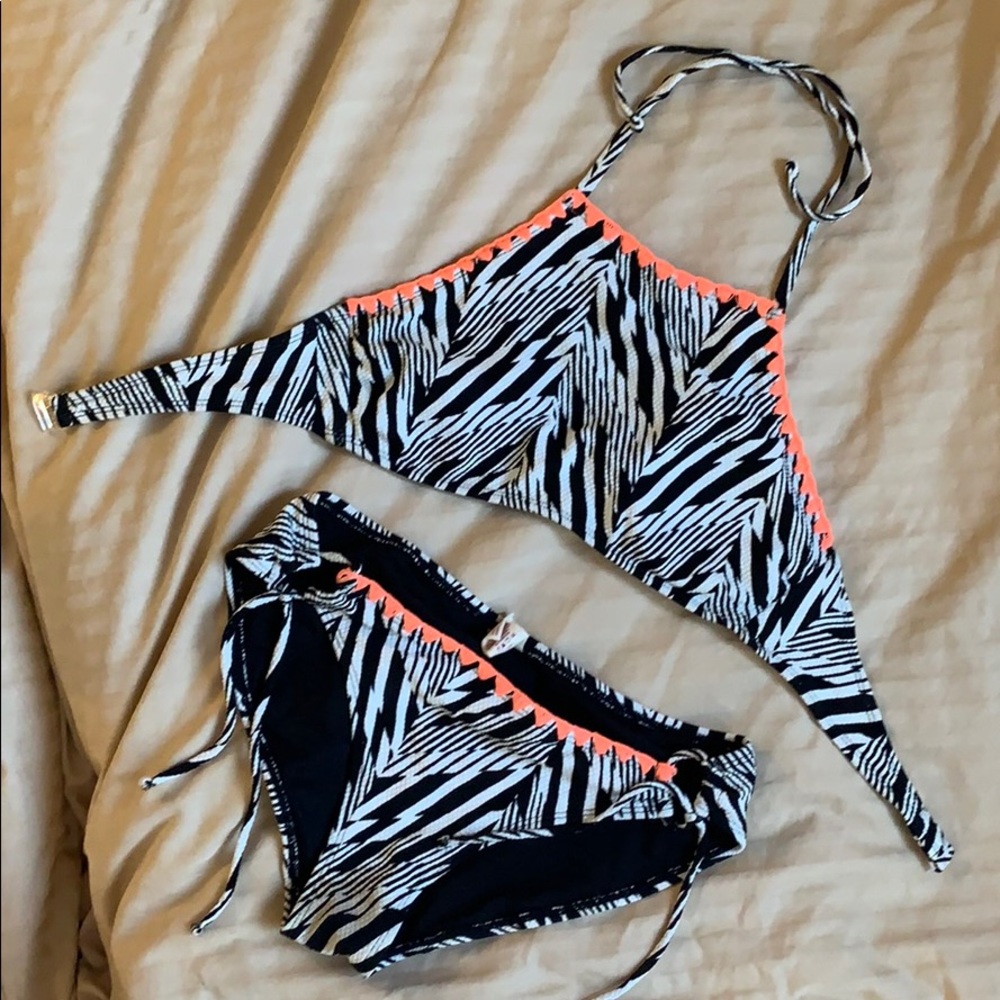 Black and white bathing suit with orange trim